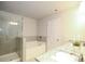 Bright bathroom boasts granite counters, tile surround soaking tub, and a glass shower at 2304 Shetley Creek Dr, Norcross, GA 30071