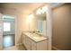 Bathroom showcasing double vanity with granite counters and doorway views to bedroom and closet at 2304 Shetley Creek Dr, Norcross, GA 30071