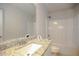 This bathroom features granite countertops, a large mirror, and a shower-tub combo at 2304 Shetley Creek Dr, Norcross, GA 30071