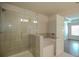 Bathroom featuring tiled shower and soaking tub behind glass enclosure at 2304 Shetley Creek Dr, Norcross, GA 30071