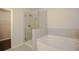 Modern bathroom featuring a glass enclosed shower and soaking tub with tile surround at 2304 Shetley Creek Dr, Norcross, GA 30071