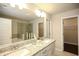 Bathroom featuring a double vanity with granite countertop, large mirror, and glass-enclosed shower and bath at 2304 Shetley Creek Dr, Norcross, GA 30071