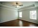 Spacious bedroom featuring hardwood floors, large windows, and a tray ceiling with a ceiling fan at 2304 Shetley Creek Dr, Norcross, GA 30071