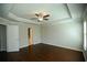 Bedroom showcasing hardwood floors, a tray ceiling, and doorways to an ensuite bathroom and closet at 2304 Shetley Creek Dr, Norcross, GA 30071