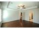 Bright bedroom with hardwood floors and ceiling fan, with entry to hall and ensuite bath at 2304 Shetley Creek Dr, Norcross, GA 30071