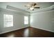 Comfortable bedroom featuring hardwood floors, natural light from two windows, and neutral paint at 2304 Shetley Creek Dr, Norcross, GA 30071