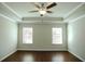 Bedroom with two windows, hardwood floors, recessed ceiling, and ceiling fan at 2304 Shetley Creek Dr, Norcross, GA 30071