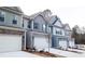 New townhomes showcasing modern architecture, a two-car garage, and manicured landscaping at 2304 Shetley Creek Dr, Norcross, GA 30071