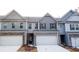 Attractive townhome featuring a well-manicured lawn, a two car garage, and stone accents at 2304 Shetley Creek Dr, Norcross, GA 30071