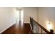 Second story hallway with hardwood floors and decorative black metal railings at 2304 Shetley Creek Dr, Norcross, GA 30071