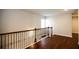 Second story hallway with hardwood floors and decorative black metal railings at 2304 Shetley Creek Dr, Norcross, GA 30071