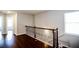 Second story hallway with hardwood floors and decorative black metal railings at 2304 Shetley Creek Dr, Norcross, GA 30071
