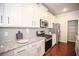 Modern kitchen with granite countertops, stainless steel appliances, and pantry at 2304 Shetley Creek Dr, Norcross, GA 30071