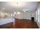 Open-concept living room and kitchen with hardwood flooring, fireplace and modern lighting at 2304 Shetley Creek Dr, Norcross, GA 30071