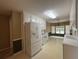 Functional kitchen with white cabinets, appliances, and an adjacent breakfast nook at 2840 Alcovy River Vw, Dacula, GA 30019