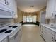 Well-lit kitchen showcasing white appliances, ample storage, and a cozy breakfast area at 2840 Alcovy River Vw, Dacula, GA 30019