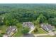 Aerial view of craftsman home showing lush surroundings and long driveway at 300 Towne Overlook Cir, Canton, GA 30114