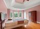 Spacious bedroom features tray ceiling, hardwood flooring, and natural lighting at 300 Towne Overlook Cir, Canton, GA 30114