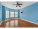 Bright bedroom boasts hardwood floors and natural light from the many windows at 300 Towne Overlook Cir, Canton, GA 30114
