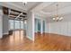 Elegant dining room features hardwood floors, white trim, and a decorative chandelier at 300 Towne Overlook Cir, Canton, GA 30114