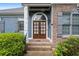 Close-up of charming entryway with a brick facade and a wooden, glass-paneled double door at 300 Towne Overlook Cir, Canton, GA 30114