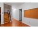 Hallway with hardwood floors and a staircase that has a lift chair system attached at 300 Towne Overlook Cir, Canton, GA 30114