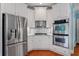 Modern kitchen with white cabinets, stainless steel appliances, and backsplash at 300 Towne Overlook Cir, Canton, GA 30114