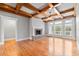 Living room with fireplace, hardwood flooring, and large windows at 300 Towne Overlook Cir, Canton, GA 30114