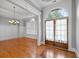 Spacious room showcasing elegant crown molding, arched windows, and gleaming hardwood floors at 300 Towne Overlook Cir, Canton, GA 30114