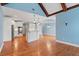 Spacious living room open to the kitchen offers hardwood floors, white cabinets, and lots of natural light at 300 Towne Overlook Cir, Canton, GA 30114