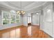 Bright living room showcasing elegant trim, chandelier, and gleaming hardwood floors at 300 Towne Overlook Cir, Canton, GA 30114