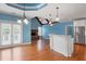 Open living room features beautiful hardwood floors, brick fireplace, and kitchen counter with white cabinets at 300 Towne Overlook Cir, Canton, GA 30114