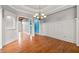 Bright living room showcasing elegant trim, chandelier, and gleaming hardwood floors at 300 Towne Overlook Cir, Canton, GA 30114