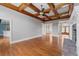 Open living room with wood beam ceiling and fireplace, perfect for entertaining at 300 Towne Overlook Cir, Canton, GA 30114