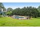 A fenced in ground pool is surrounded by a lush green lawn and mature trees at 300 Towne Overlook Cir, Canton, GA 30114