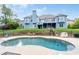 A kidney-shaped pool with patio and fence surrounds the home's backyard, with easy access to the home at 300 Towne Overlook Cir, Canton, GA 30114