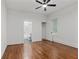 Bedroom showcasing hardwood floors, a ceiling fan, closet, and a bathroom with a white-tiled shower at 360 Ponce De Leon Ave Ne # 1, Atlanta, GA 30305