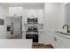 Bright, remodeled kitchen featuring stainless appliances and white cabinetry at 360 Ponce De Leon Ave Ne # 1, Atlanta, GA 30305