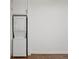 Stackable washing machine and dryer unit built into wall cabinetry, adjacent to hardwood floor at 360 Ponce De Leon Ave Ne # 1, Atlanta, GA 30305