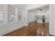 Bright living room featuring hardwood floors, large windows, and an open layout leading into the kitchen at 360 Ponce De Leon Ave Ne # 1, Atlanta, GA 30305