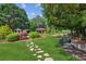 Professionally landscaped backyard with stone walking path, lush greenery, manicured lawn, and gazebo at 3903 Hazelhurst Dr, Marietta, GA 30066
