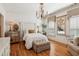 Cozy bedroom with hardwood floors, chandelier, and large windows with custom window coverings at 3903 Hazelhurst Dr, Marietta, GA 30066