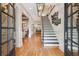 Elegant entryway with hardwood floors, staircase with black and white risers, and decorative lighting at 3903 Hazelhurst Dr, Marietta, GA 30066