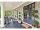 Covered front porch featuring dark flooring, rocking chairs, and stylish decor, perfect for relaxing outdoors at 3903 Hazelhurst Dr, Marietta, GA 30066