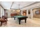 Entertain in style in this game room featuring a pool table, stone accent wall, and elegant decor at 3903 Hazelhurst Dr, Marietta, GA 30066