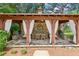 Outdoor dining area in covered gazebo with stone and wood beam architecture and white drapes for privacy at 3903 Hazelhurst Dr, Marietta, GA 30066