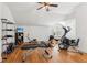 Home gym featuring multiple workout machines, hardwood floors, and a vaulted ceiling at 3903 Hazelhurst Dr, Marietta, GA 30066