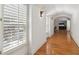 Bright hallway with hardwood floors and natural light pouring in from shuttered windows at 3903 Hazelhurst Dr, Marietta, GA 30066