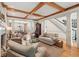 Expansive living room with hardwood floors, fireplace, wood-beamed ceiling, and open to the dining area at 3903 Hazelhurst Dr, Marietta, GA 30066