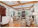 Bright living room with hardwood floors, fireplace, wood beams, and a spacious layout, perfect for entertaining at 3903 Hazelhurst Dr, Marietta, GA 30066